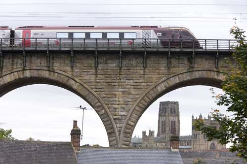  DescriptionLooking through the archways of a viaduct as a train travels across towards Durham Cathedral in County Durham. Durham Cathedral is the greatest Norman building in England, perhaps even in Europe. It is cherished not only for its architecture but also for its incomparable setting. For this reason it was inscribed together with the Castle as one of Britain's first World Heritage Sites., Durham, County Durham, England. Additional Credit: One North East